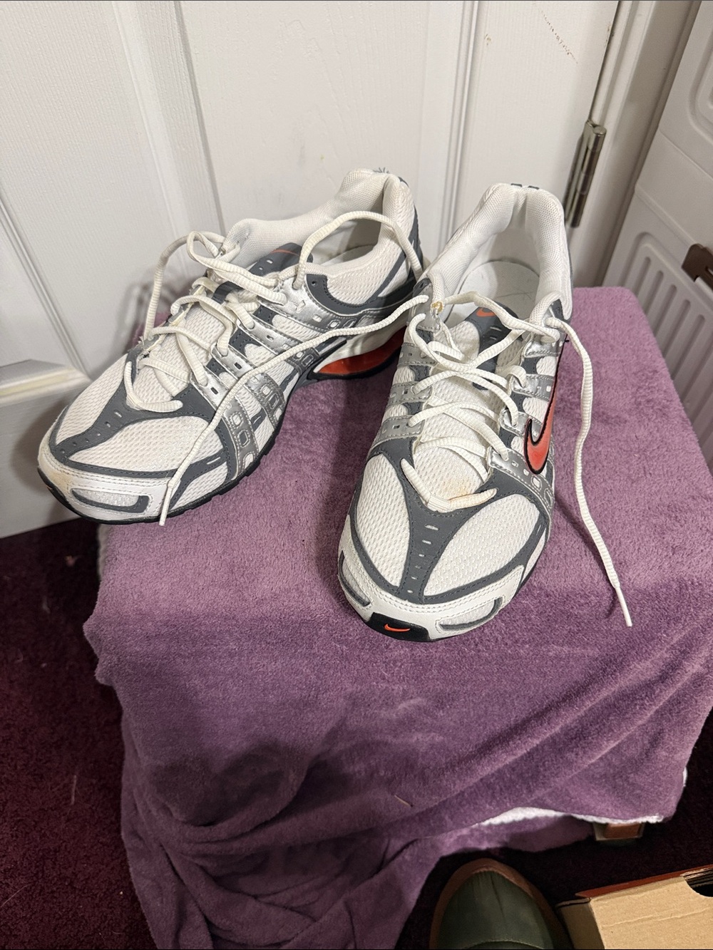 Nike White and Gray Athletic Sneakers with Orange Swoosh Accent